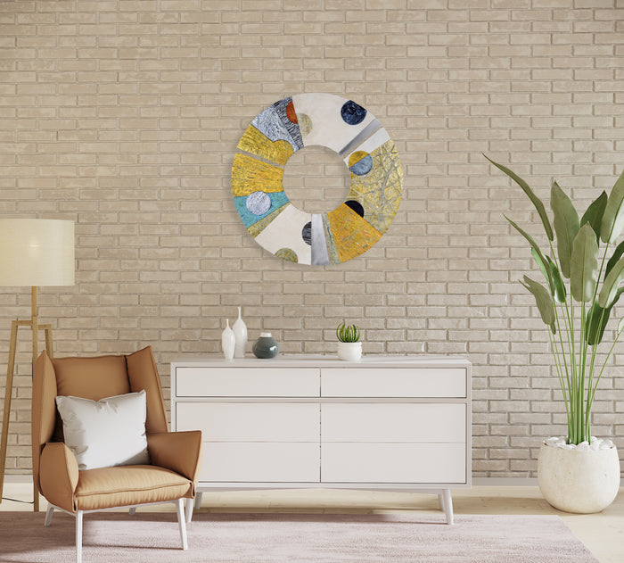 The artwork 'Convex #35' by Francie Hester features a circular composition of three aluminum segments with textural acrylic and cold wax elements. The 29-inch diameter piece showcases a dynamic interplay of yellow, blue, and white tones arranged in a segmented wheel pattern, creating a modern abstract aesthetic with rich surface variations and metallic undertones.