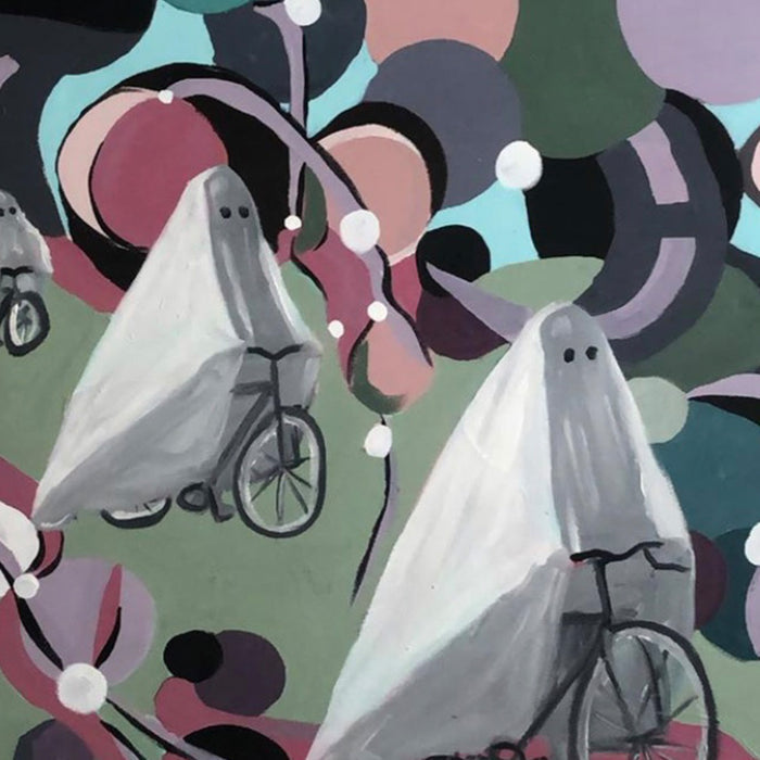 The artwork 'Ghosted' by Nikki Shapiro features playful ghost figures riding bicycles against a vibrant abstract background of interlocking circles in turquoise, pink, and forest green. The ghosts are rendered in white with simple black details, floating whimsically through a pattern of white dots and curved shapes. Acrylic and oil on canvas, 44x36 inches.
