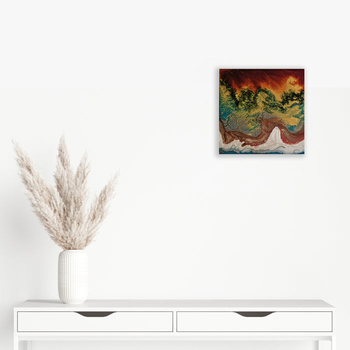 The artwork 'Study 141' by Sabrina Puppin features an abstract composition with flowing synthetic glazes on wood, displaying rich burgundy, turquoise, and golden hues that create a dynamic marbled effect. The colors blend and swirl organically, reminiscent of aerial landscapes or geological formations. 12x12 inches. By Sabrina Puppin.