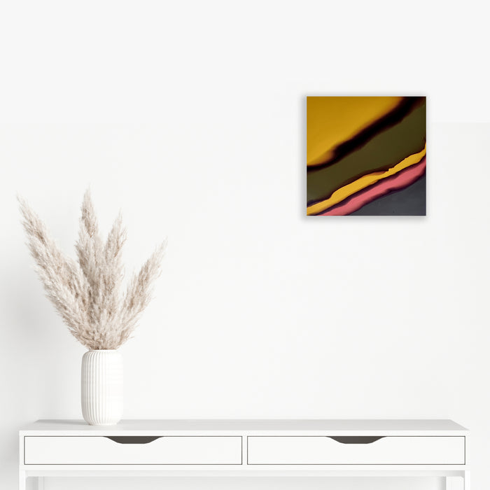 The artwork 'Study 166' by Sabrina Puppin features bold diagonal stripes in mustard yellow, olive green, coral pink, and deep charcoal, creating a dynamic abstract composition. The synthetic glazes on wood create smooth, flowing transitions between colors, suggesting a fluid, contemporary aesthetic. The 12x12 inch piece demonstrates striking color contrasts and minimalist design. By Sabrina Puppin.